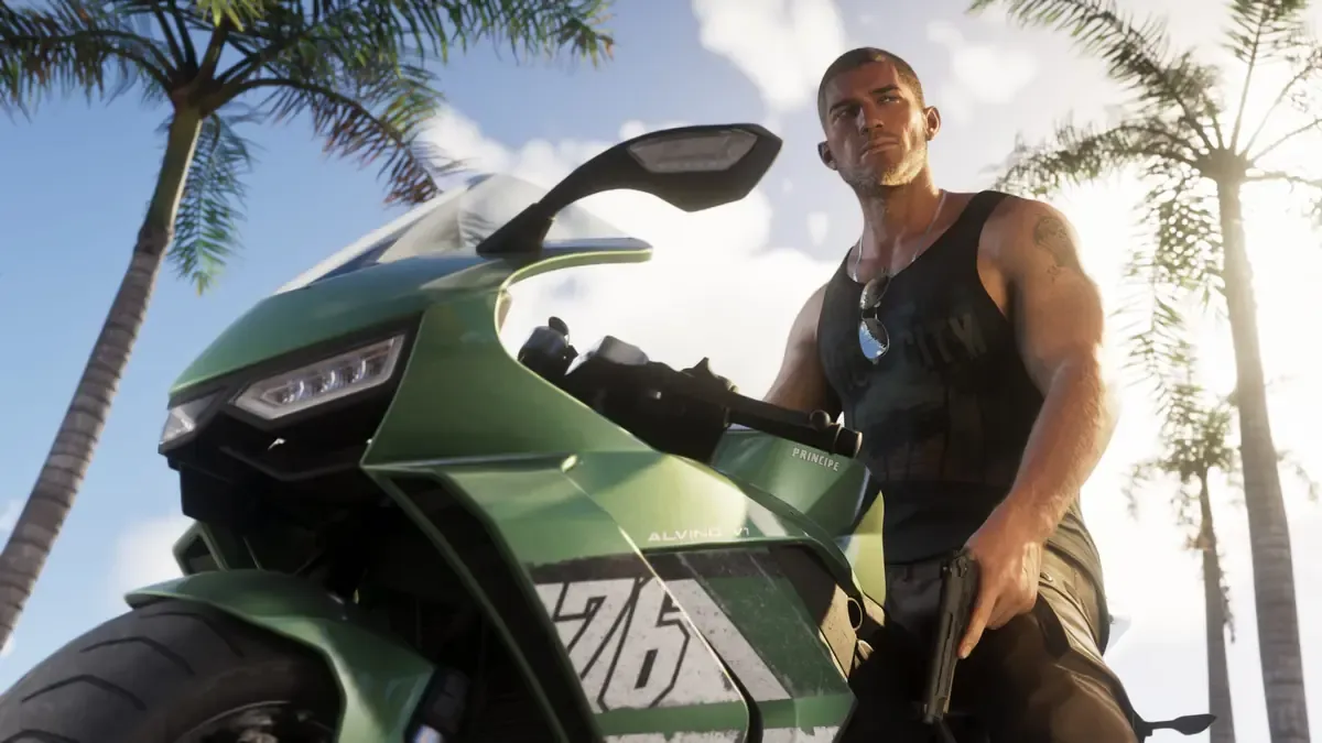 Jason Duval sitting on a green sports bike under palm trees